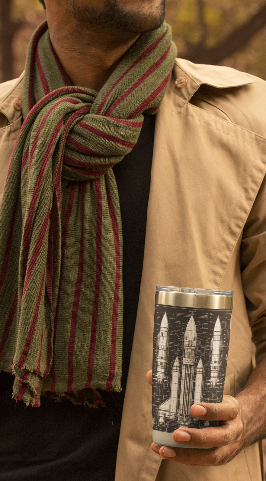 A young man holding his Dark Rocket Tumbler